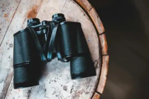 binoculars-on-a-wooden-table